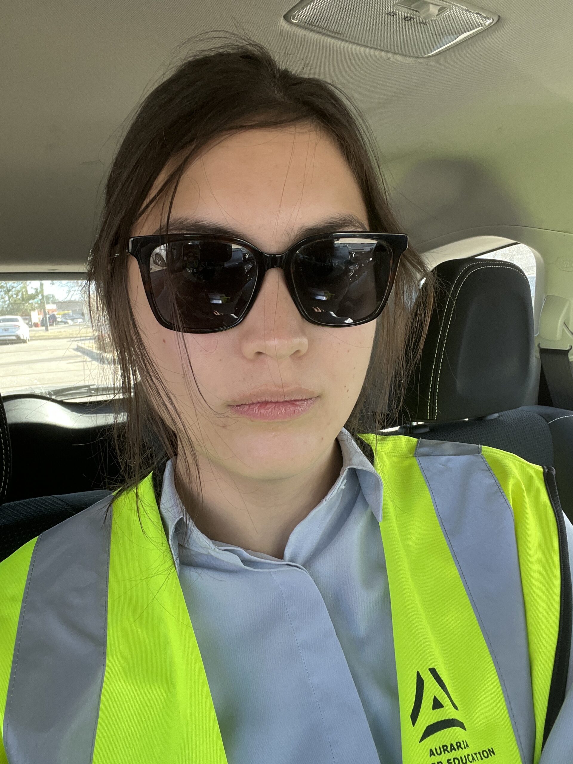 woman wearing sunglasses and high visibility vest